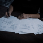 Admissions coordinator reviewing plan documents to verify behavioral health benefits before admission