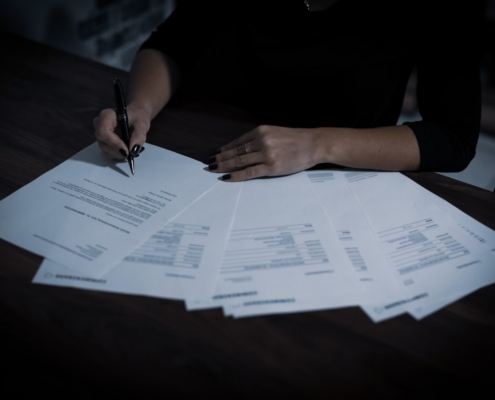 Admissions coordinator reviewing plan documents to verify behavioral health benefits before admission