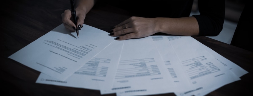 Admissions coordinator reviewing plan documents to verify behavioral health benefits before admission